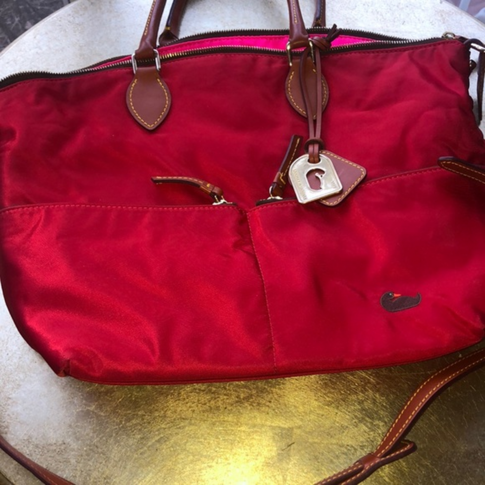 Dooney Bourke red vinyl 2 zippered pockets across the front hot pink interior‎